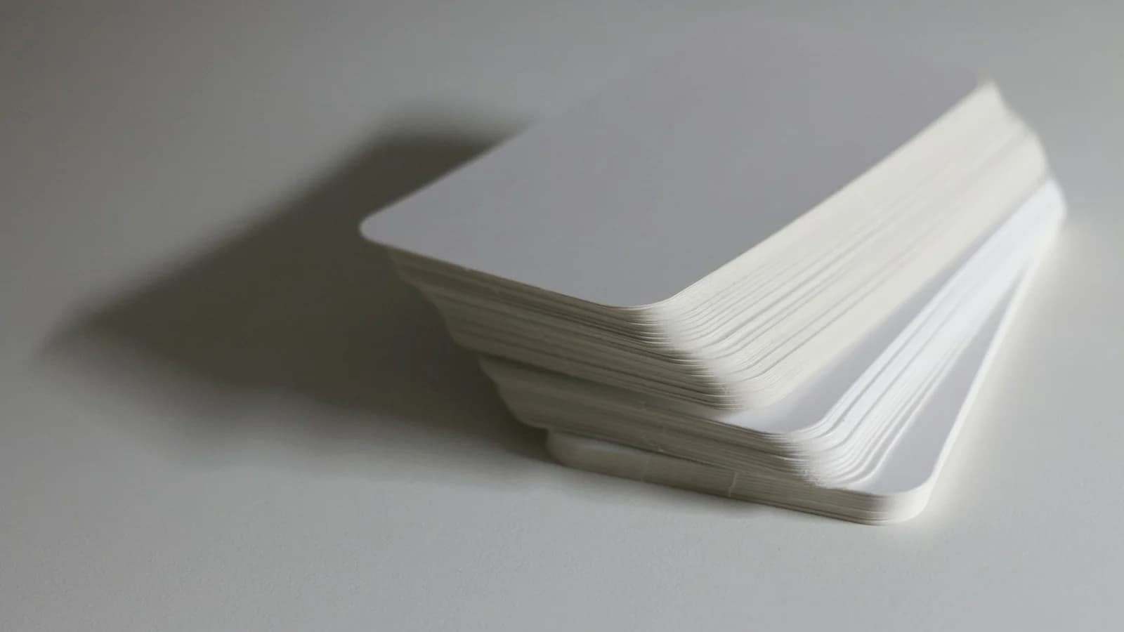 A close-up of stacked white index cards with a clean, minimal aesthetic