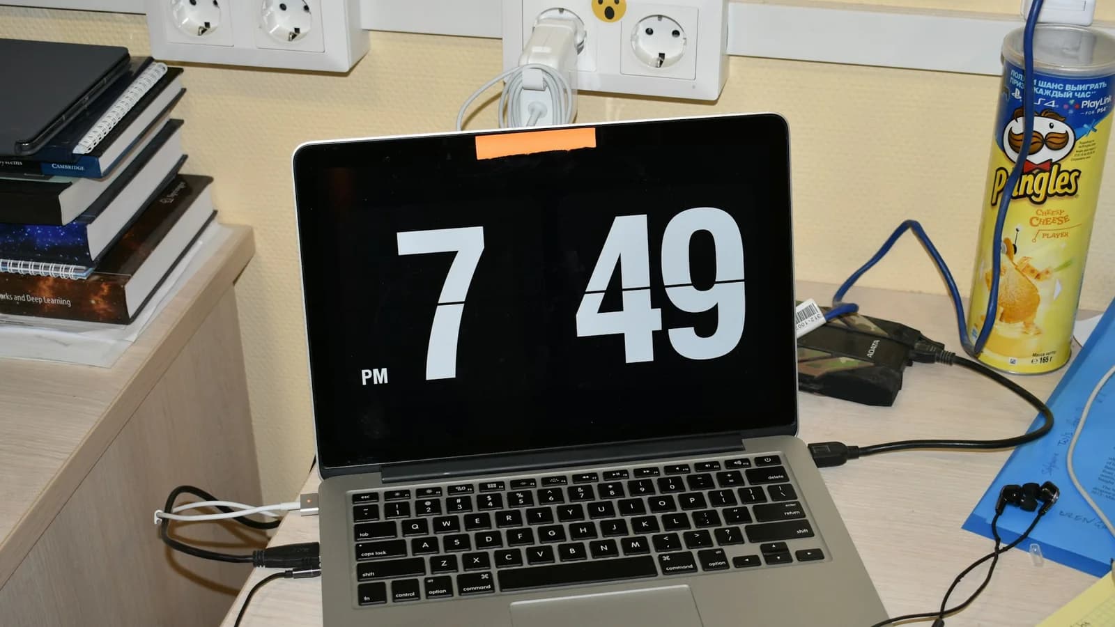 A digital clock displayed on a laptop next to a coffee mug