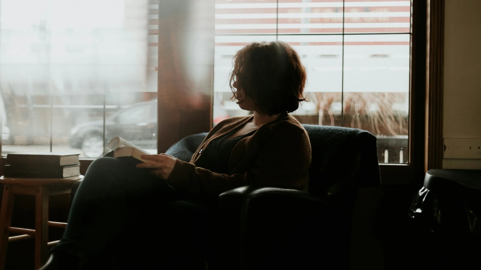 A student sitting on a sofa thinking with a calm expression
