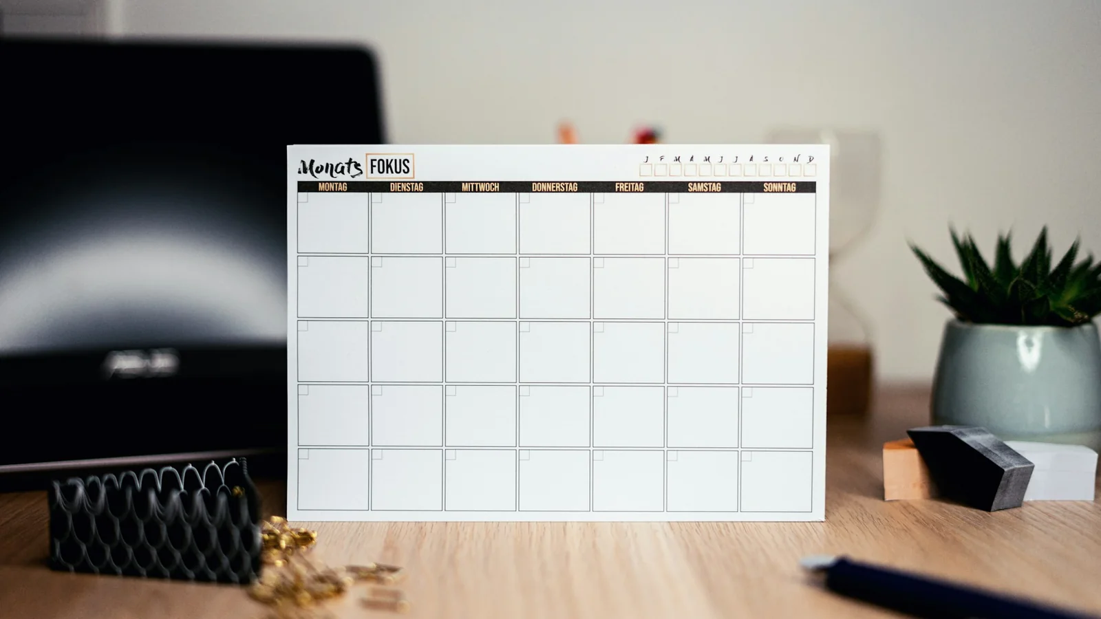 A blank white wall calendar with no writing on it