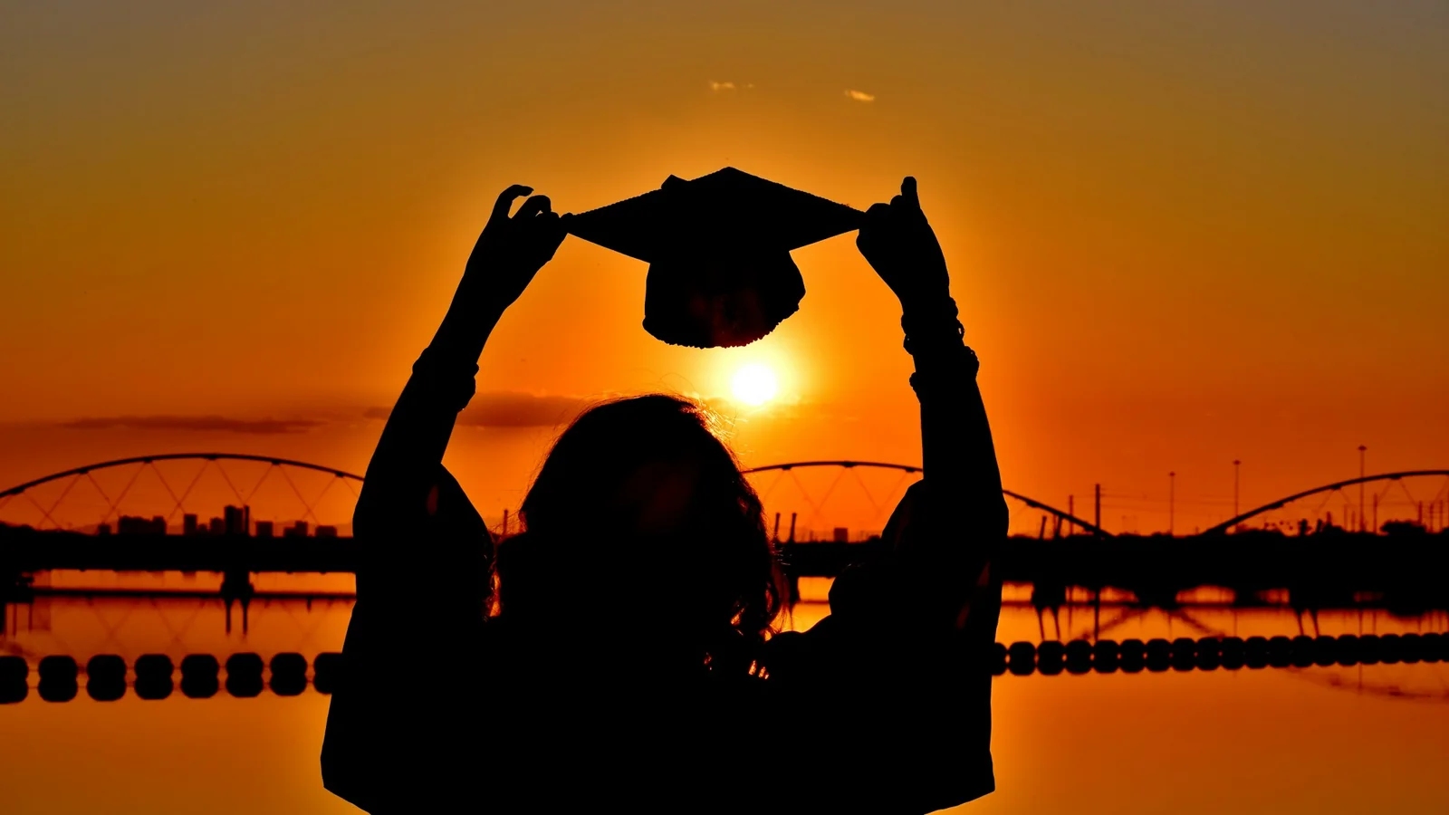 A young woman holding a heart-shaped paper near her chest