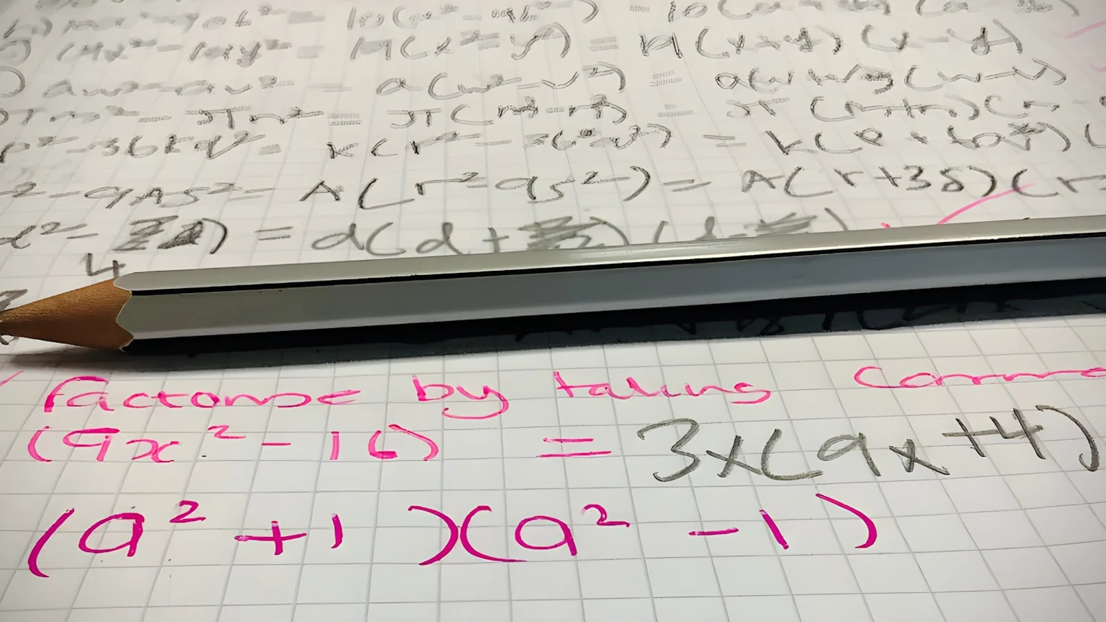 A pencil resting on a sheet of paper with handwritten calculus working